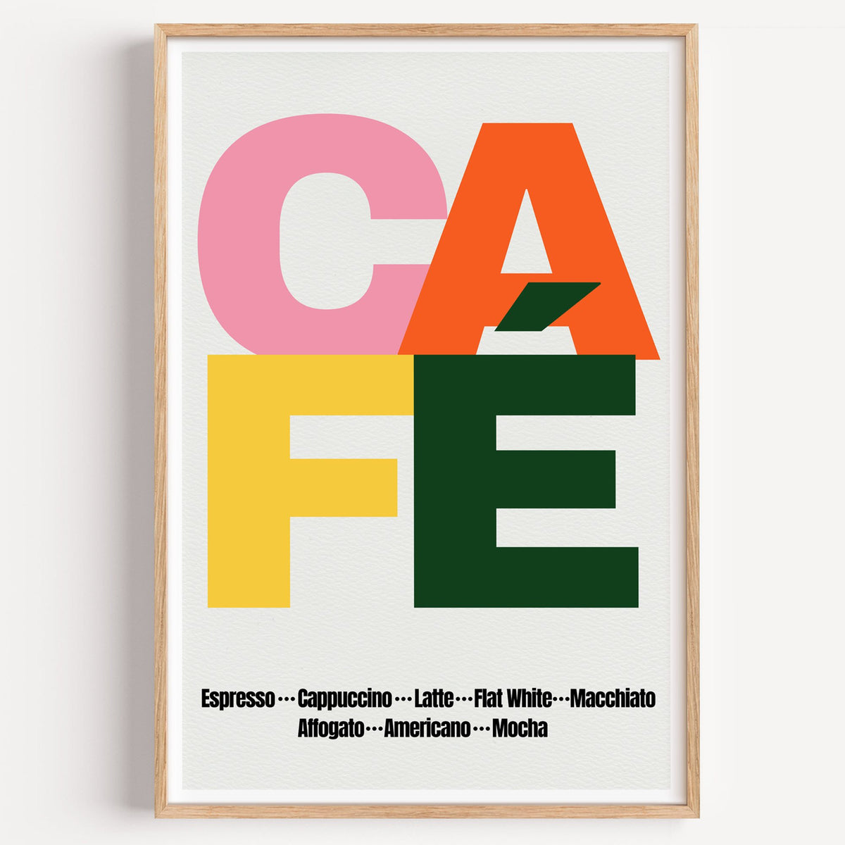 CAFÉ color block coffee menu print in a light oak frame on a plain white wall