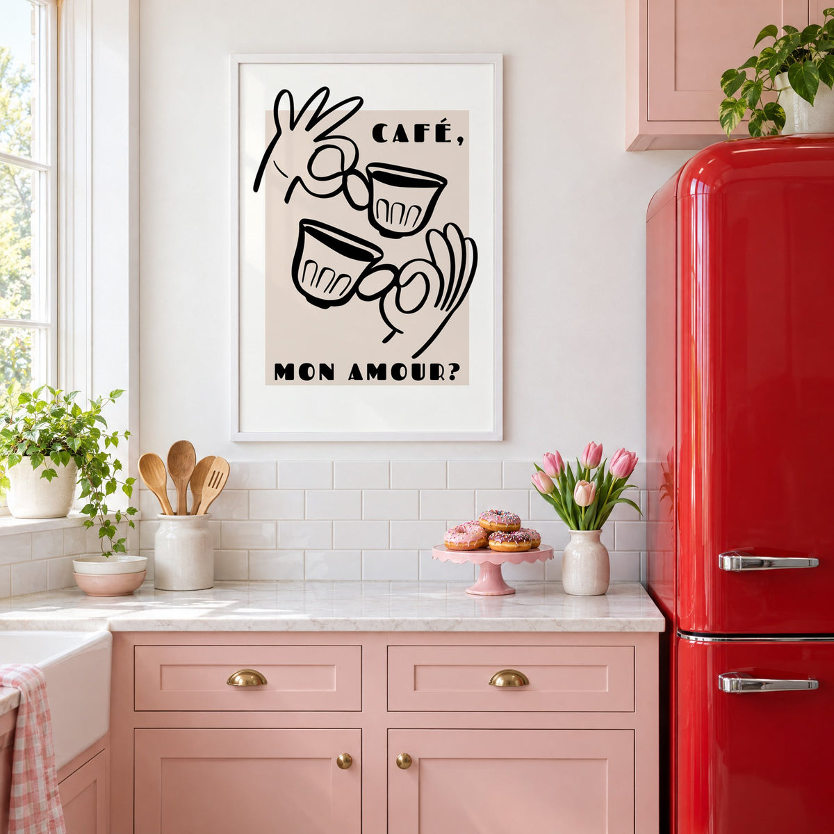 Café mon amour black line print in a white frame in a pink kitchen beside a red retro fridge