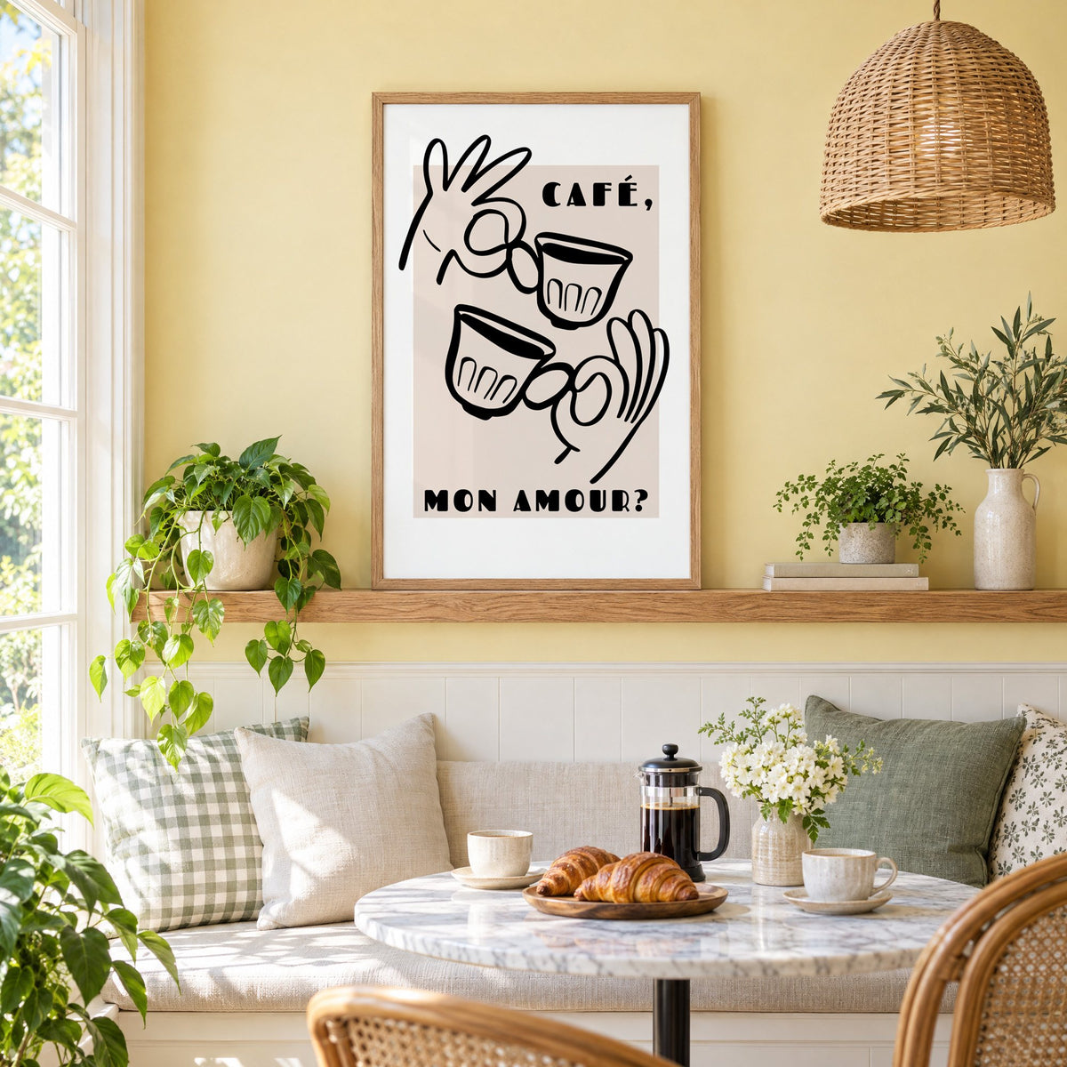 Café mon amour black line print in an oak frame on a picture ledge above a sunny breakfast nook