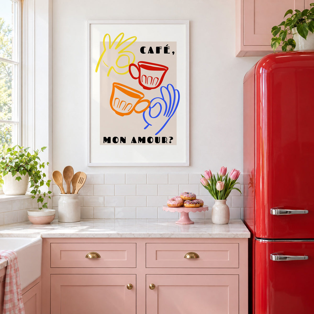 Café mon amour yellow hand beige print in a white frame in a pink kitchen beside a red retro fridge
