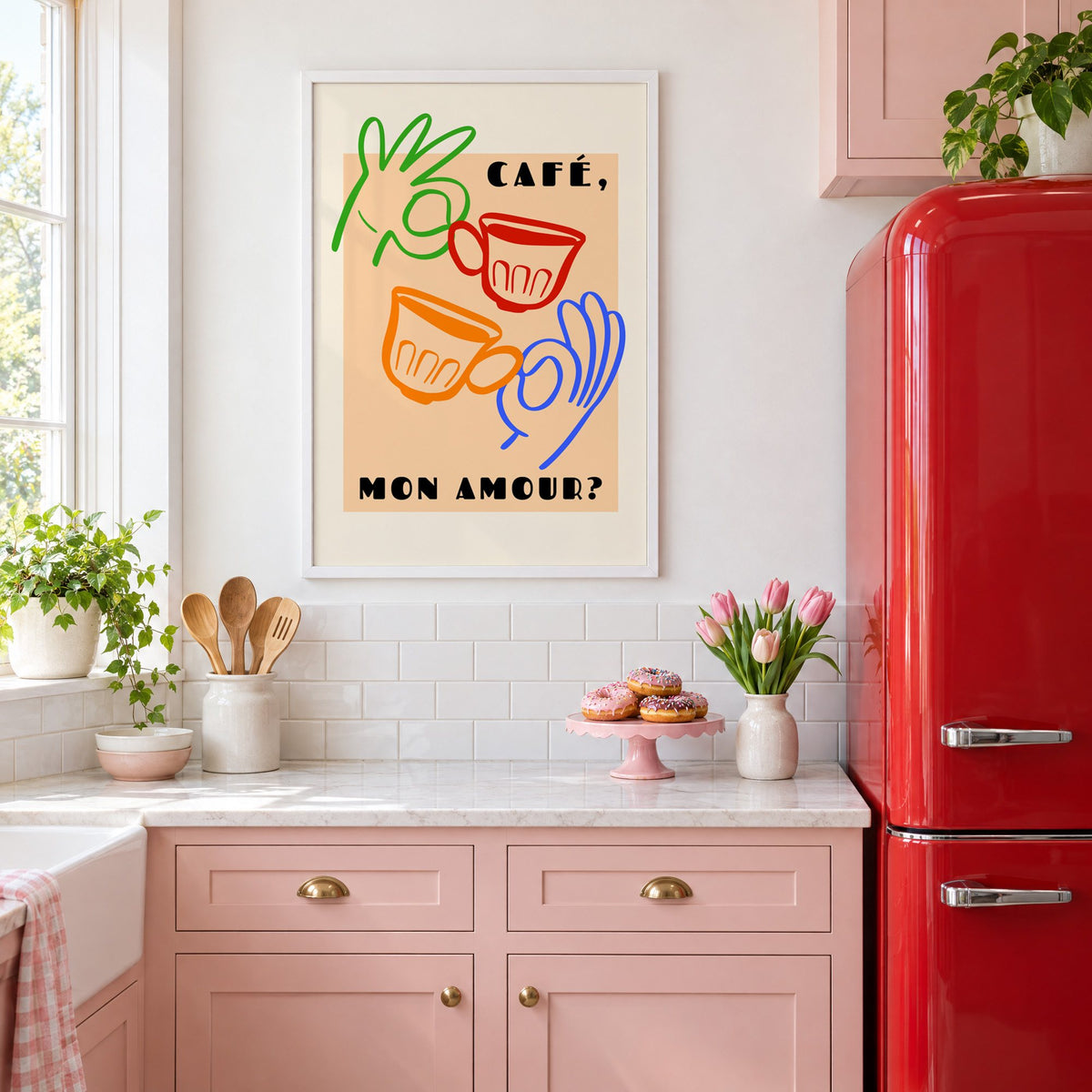 Café mon amour peach coffee cups print in a white frame in a pink kitchen beside a red retro fridge