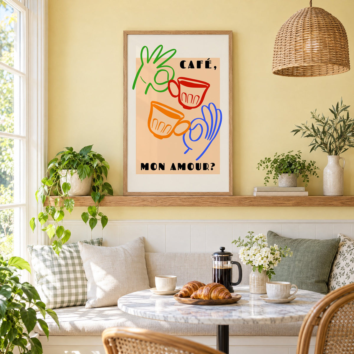Café mon amour peach coffee cups print in an oak frame on a picture ledge above a sunny breakfast nook