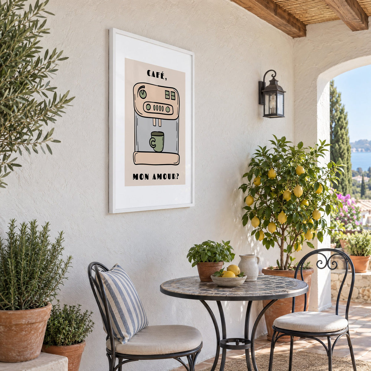 Café mon amour espresso machine print in a white frame on a sunny patio wall beside a potted lemon tree