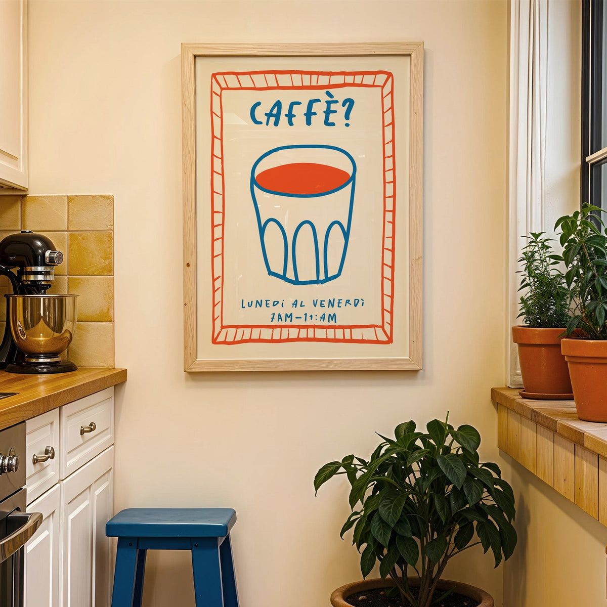 Caffe cobalt glass print in a wood frame on a yellow tiled kitchen wall
