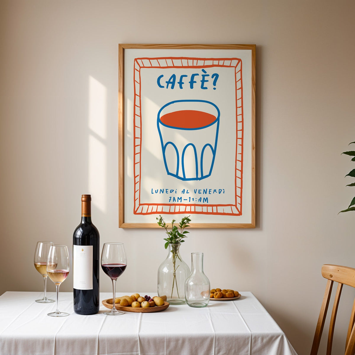 Caffe cobalt glass print in an oak frame above a table laid with wine and glasses