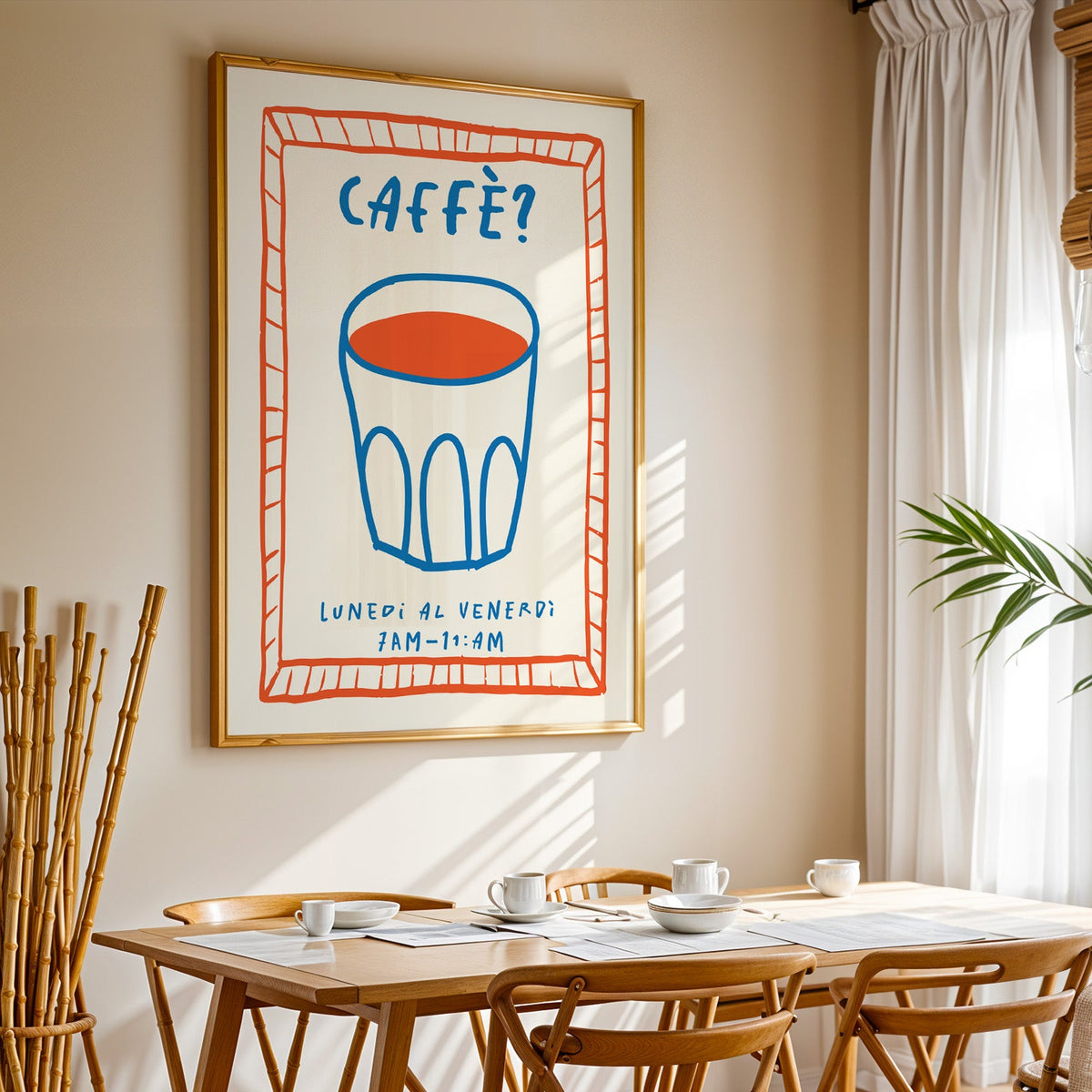 Caffe cobalt glass print in a gold frame above a sunlit breakfast table
