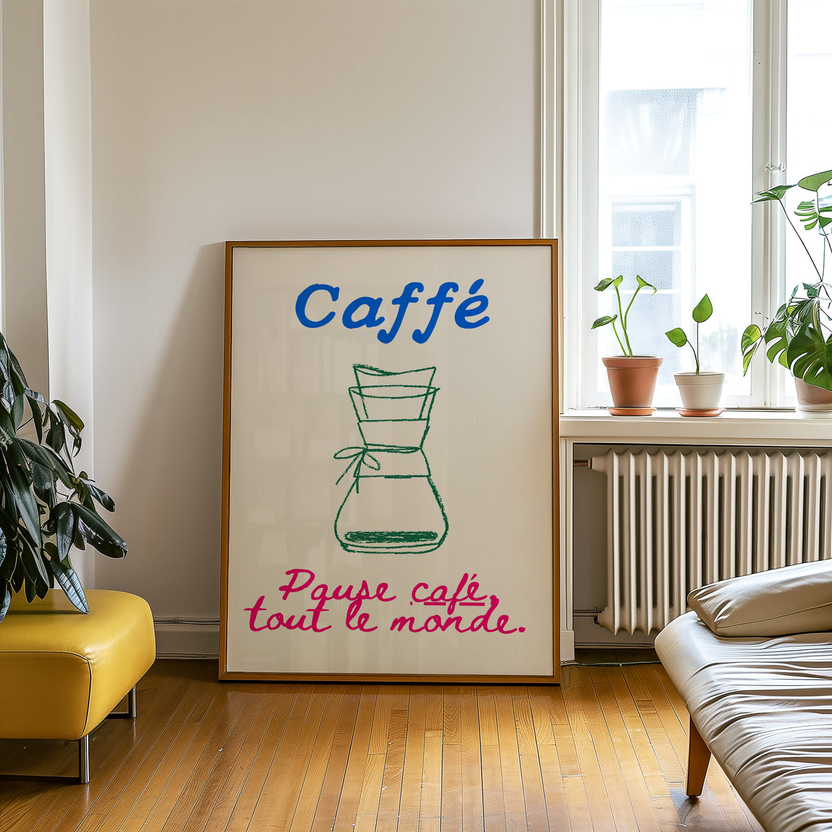 Chemex pause cafe coffee print in an oak frame leaning on a wooden floor beside a yellow leather bench