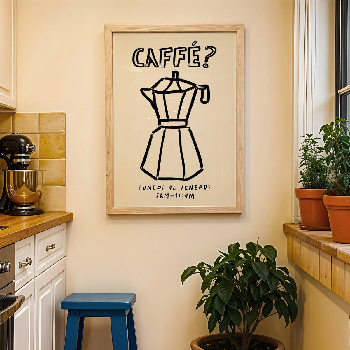 Black line moka pot print in a wood frame on a yellow tiled kitchen wall