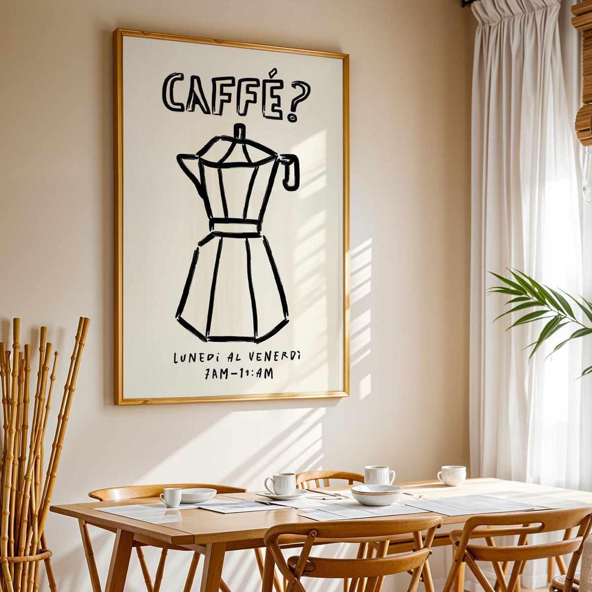 Black line moka pot print in a gold frame above a sunlit breakfast table