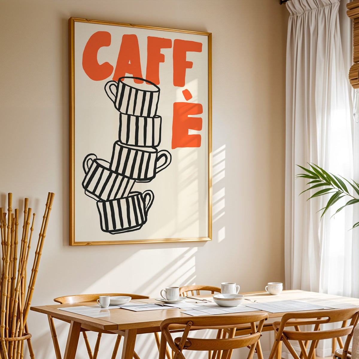 Stacked espresso cups print in a gold frame above a sunlit breakfast table