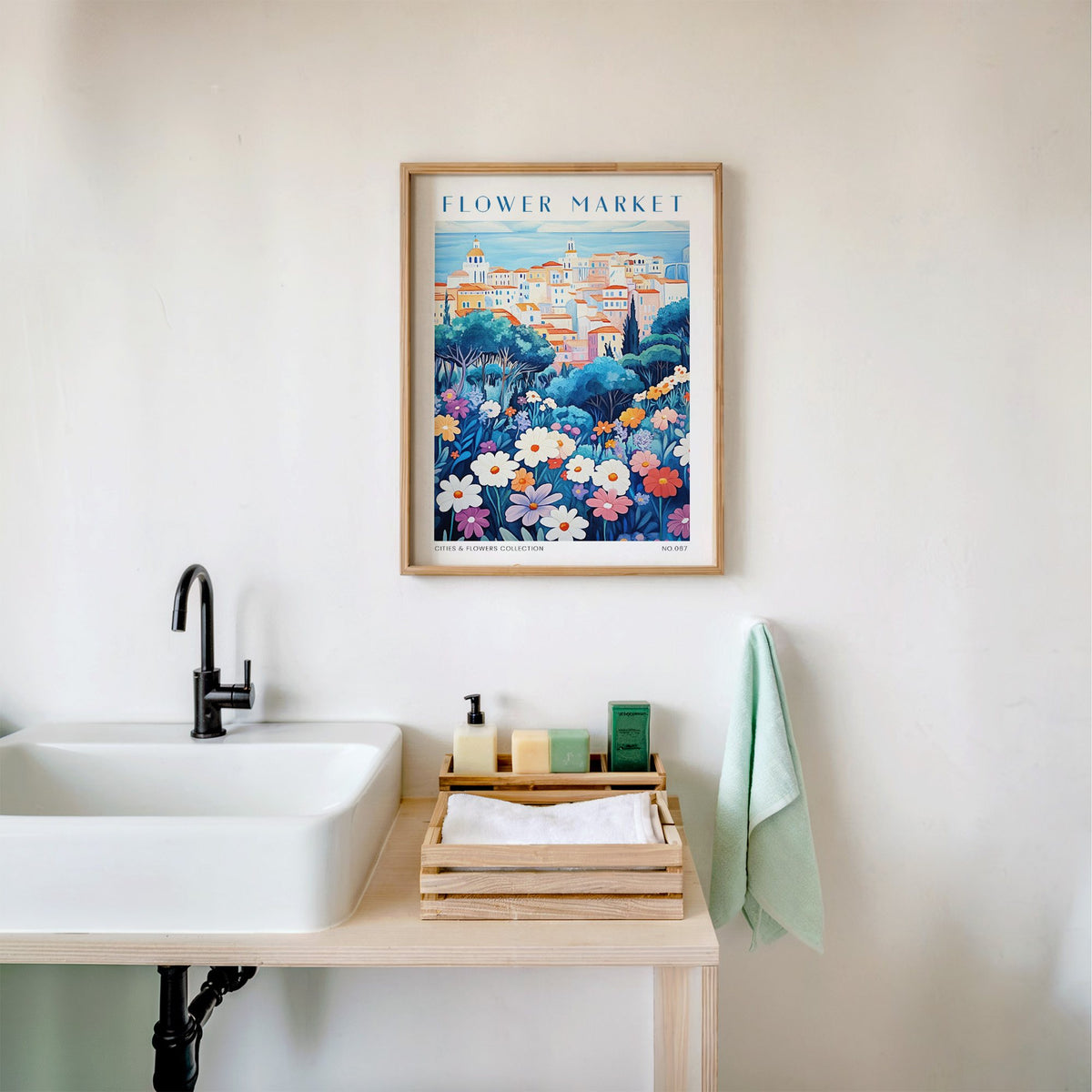 Cagliari flower market print in an oak frame above a white bathroom sink with folded towels