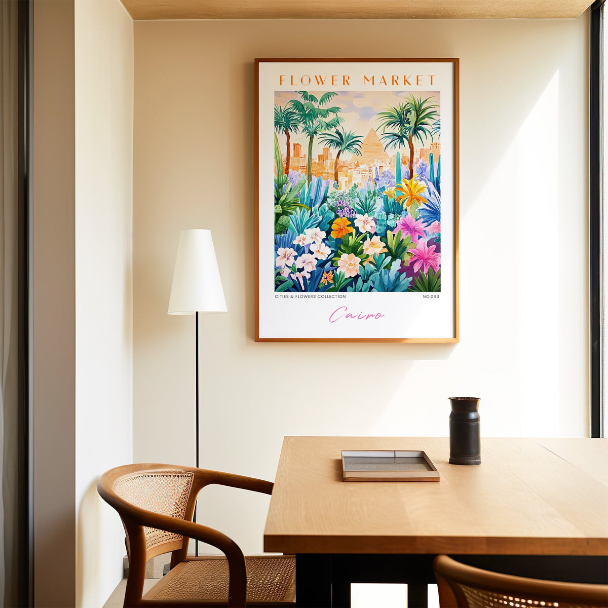 Cairo flower market print in an oak frame above a dining table and cane chair