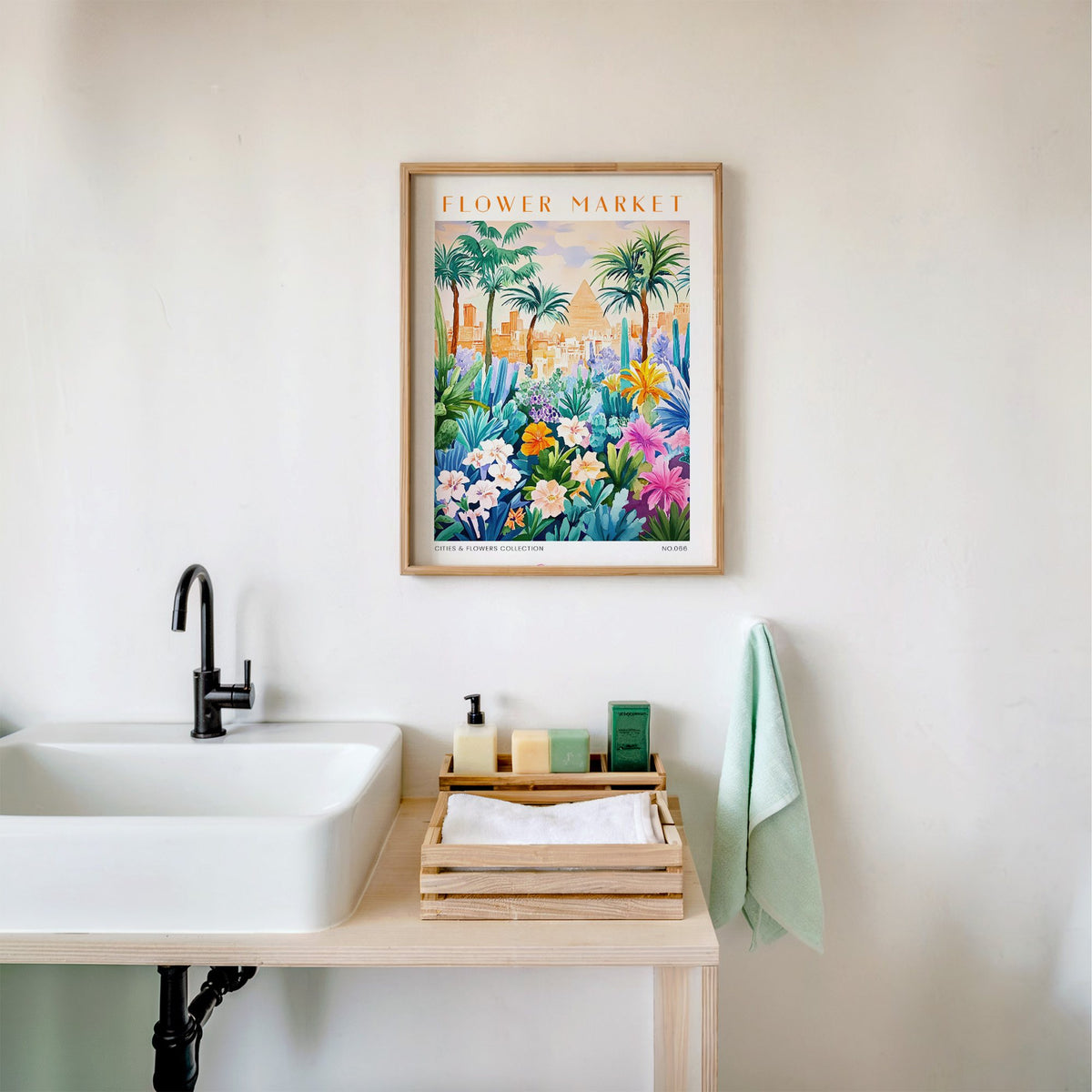 Cairo flower market print in an oak frame above a white bathroom sink with folded towels