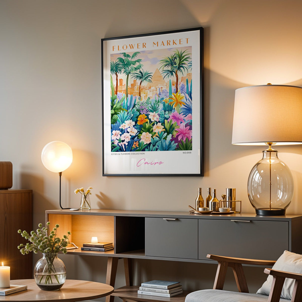 Cairo flower market print in a black frame above a grey media console with a glass table lamp