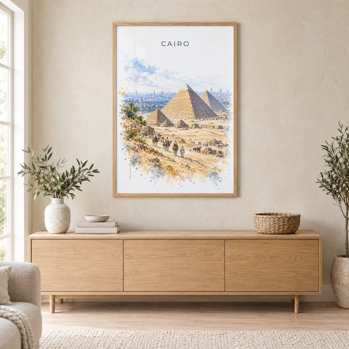 Cairo watercolor print in an oak frame above a light wood sideboard in a Scandinavian living room