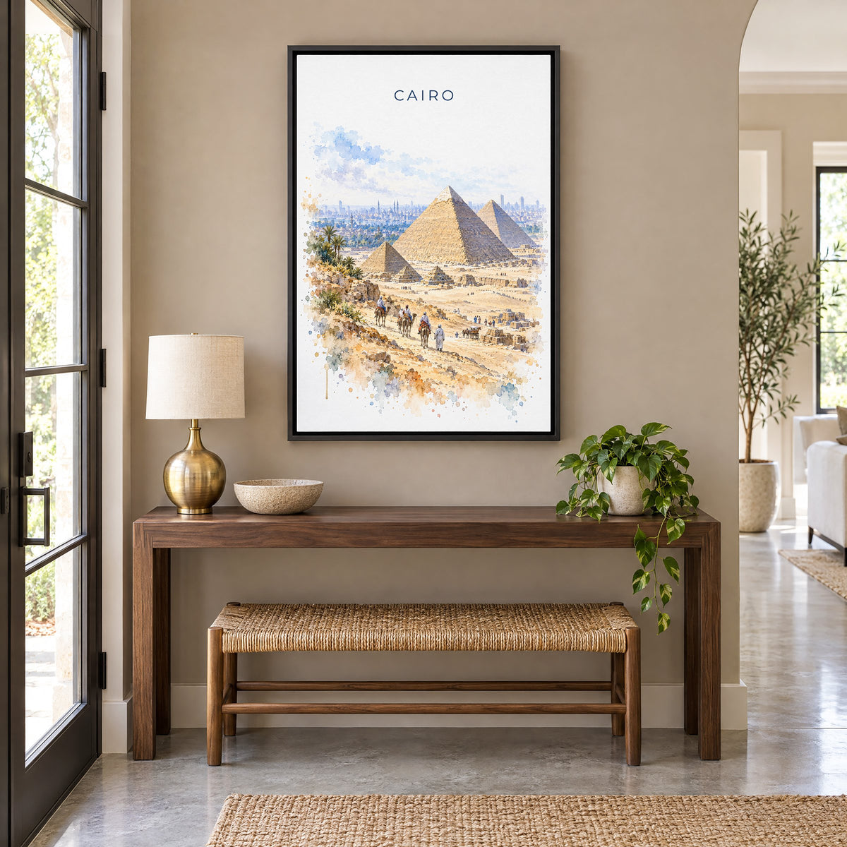 Cairo watercolor print as a black floater canvas above a walnut console and woven bench in an entryway