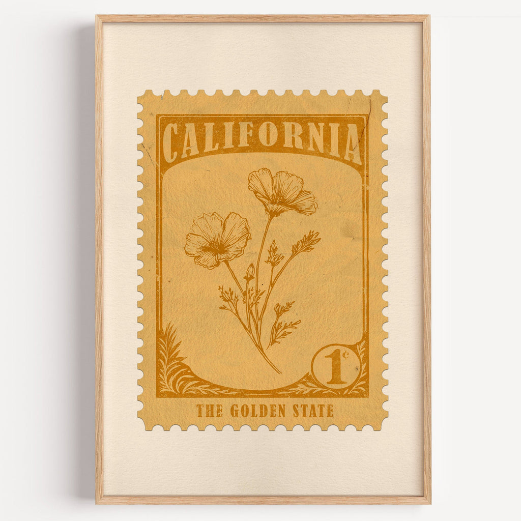 California state flower stamp print in amber gold on tan, light oak frame on a plain white wall