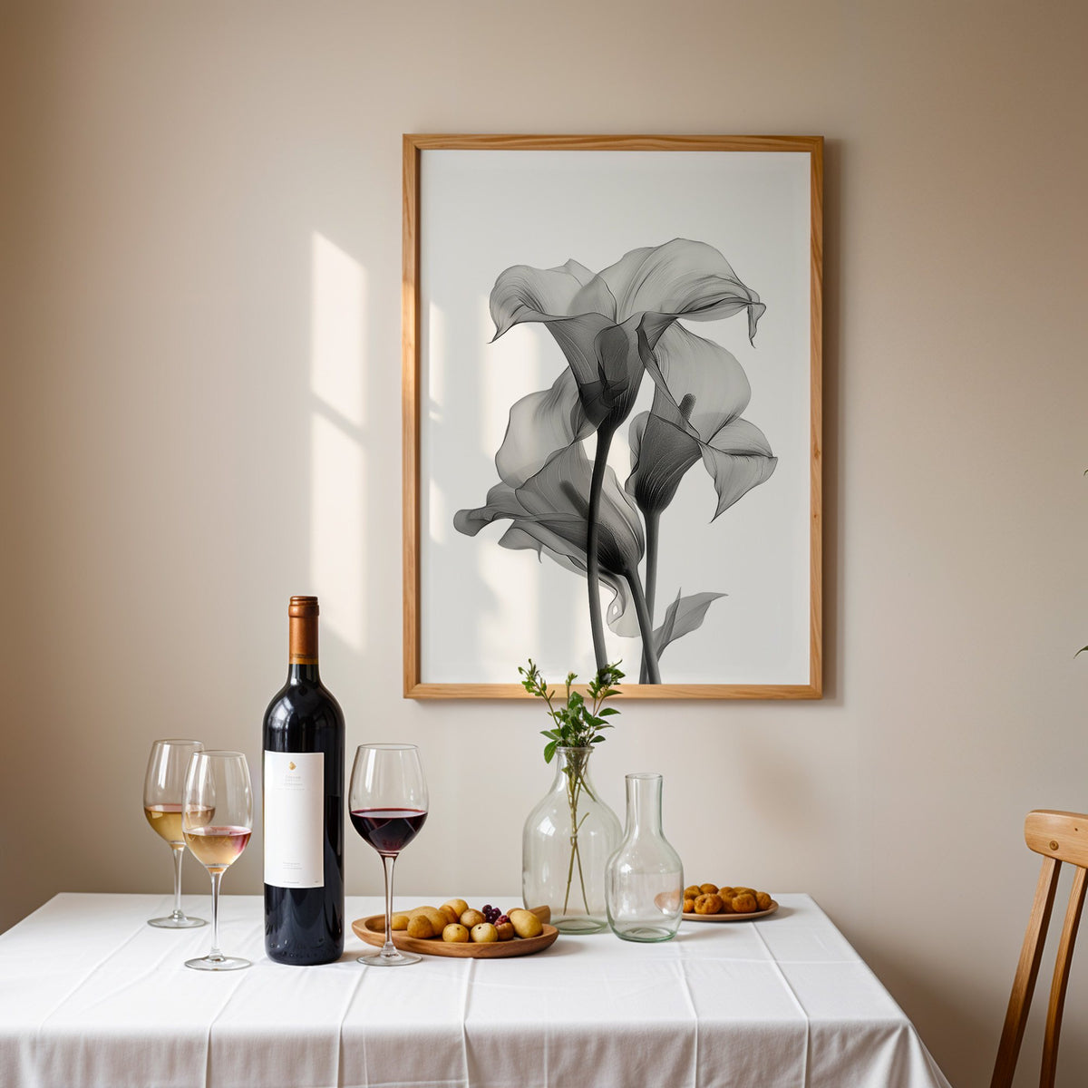 Translucent calla lily X-ray flowers print in an oak frame above a table set with red wine and glasses