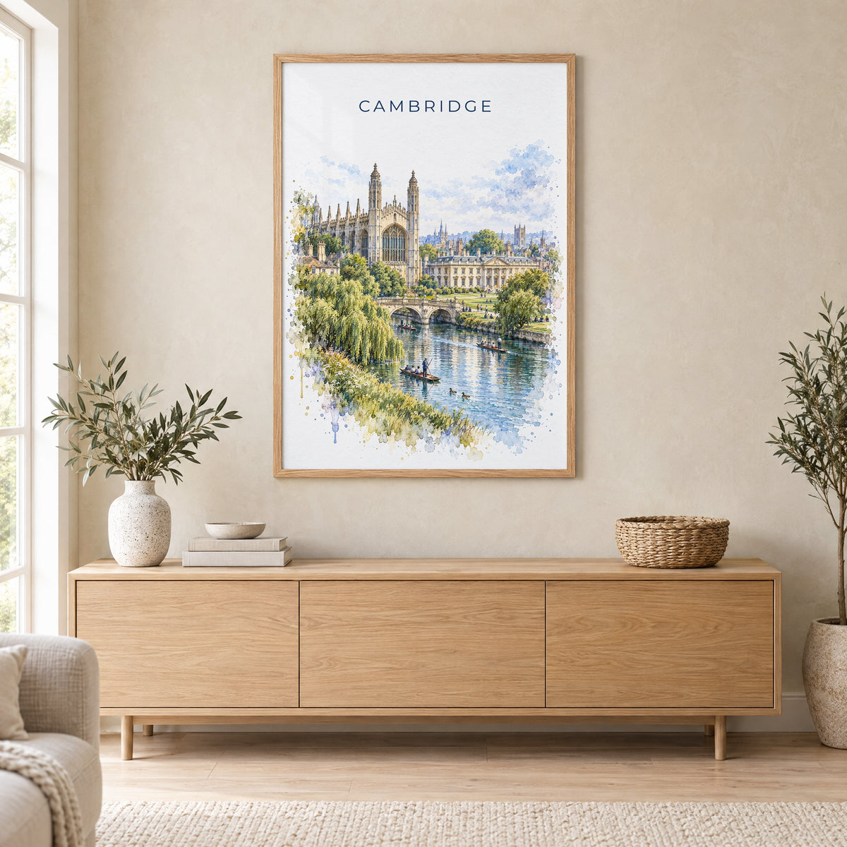 Cambridge, England watercolor print in an oak frame above a light wood sideboard in a Scandinavian living room