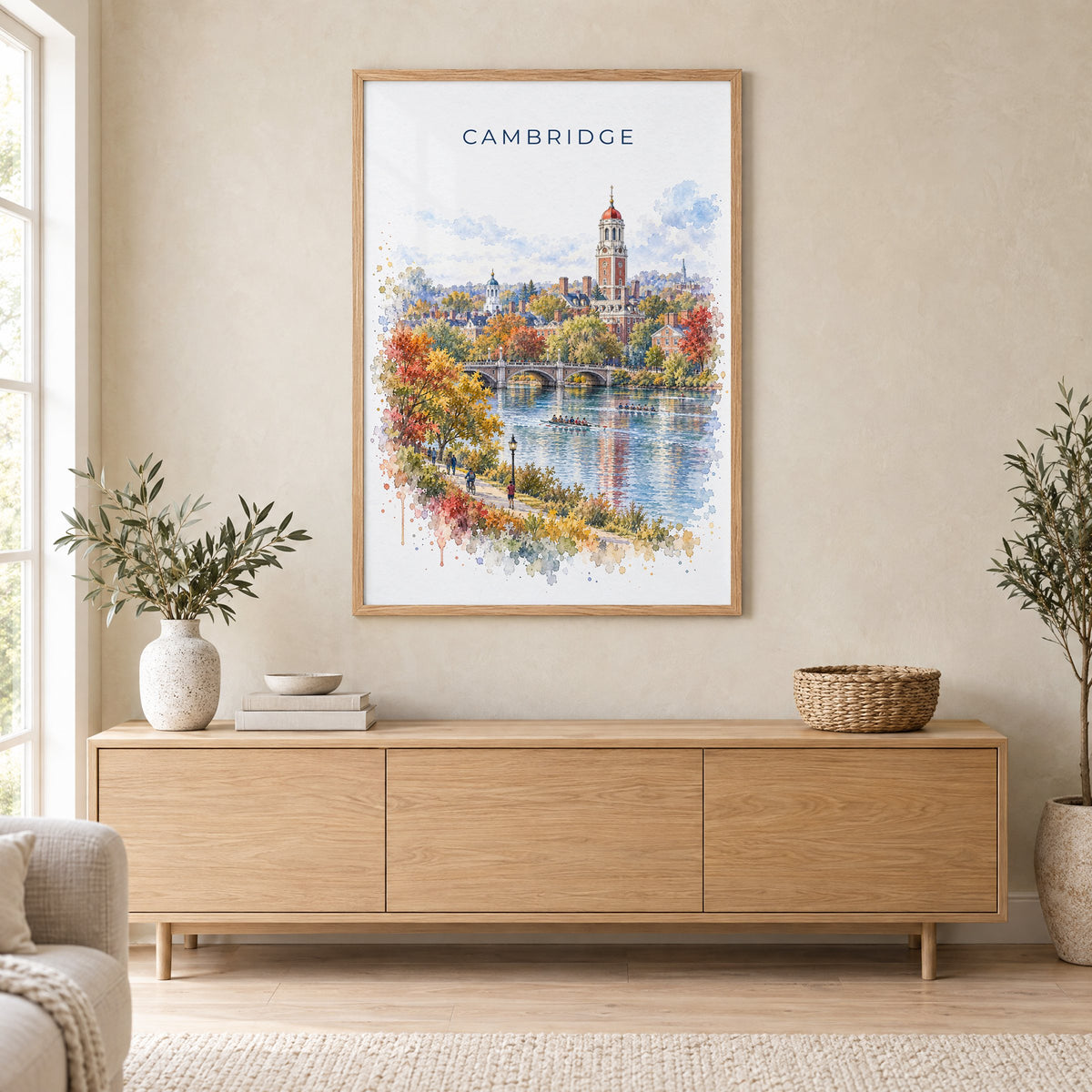 Cambridge, Massachusetts watercolor print in an oak frame above a light wood sideboard in a Scandinavian living room