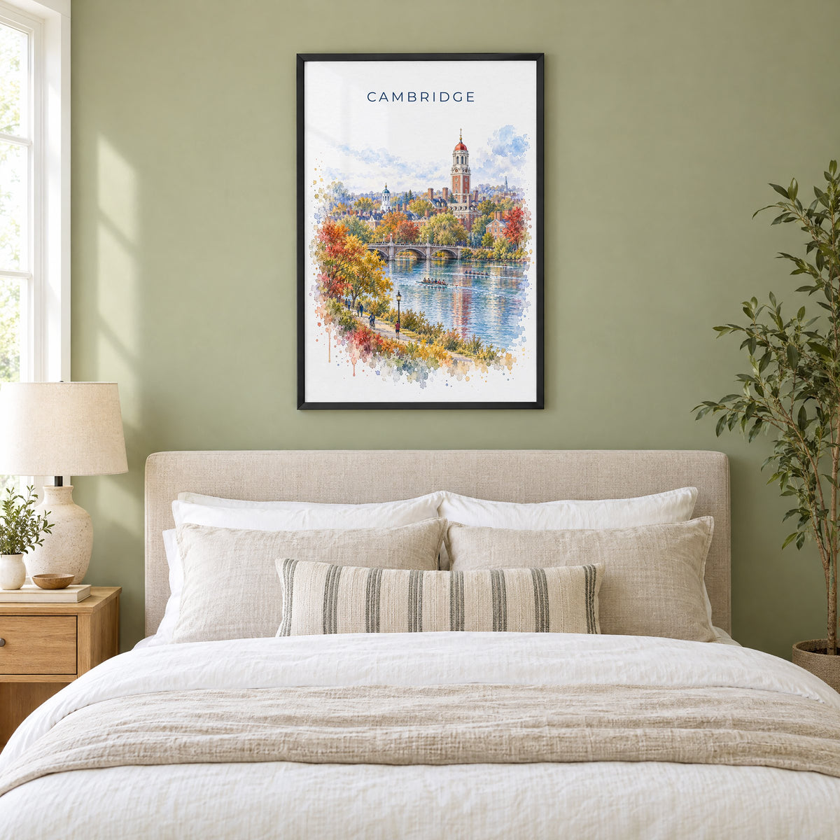 Cambridge, Massachusetts watercolor print in a black frame above an upholstered headboard in a sage green bedroom