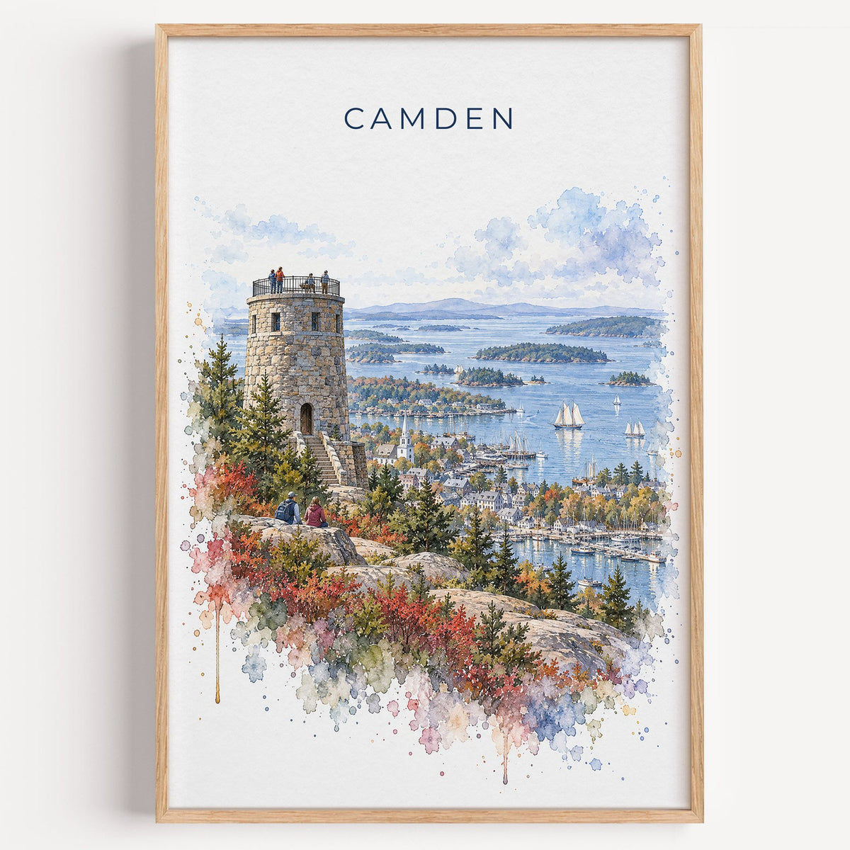 Camden, Maine watercolor print in a light oak frame on a plain white wall