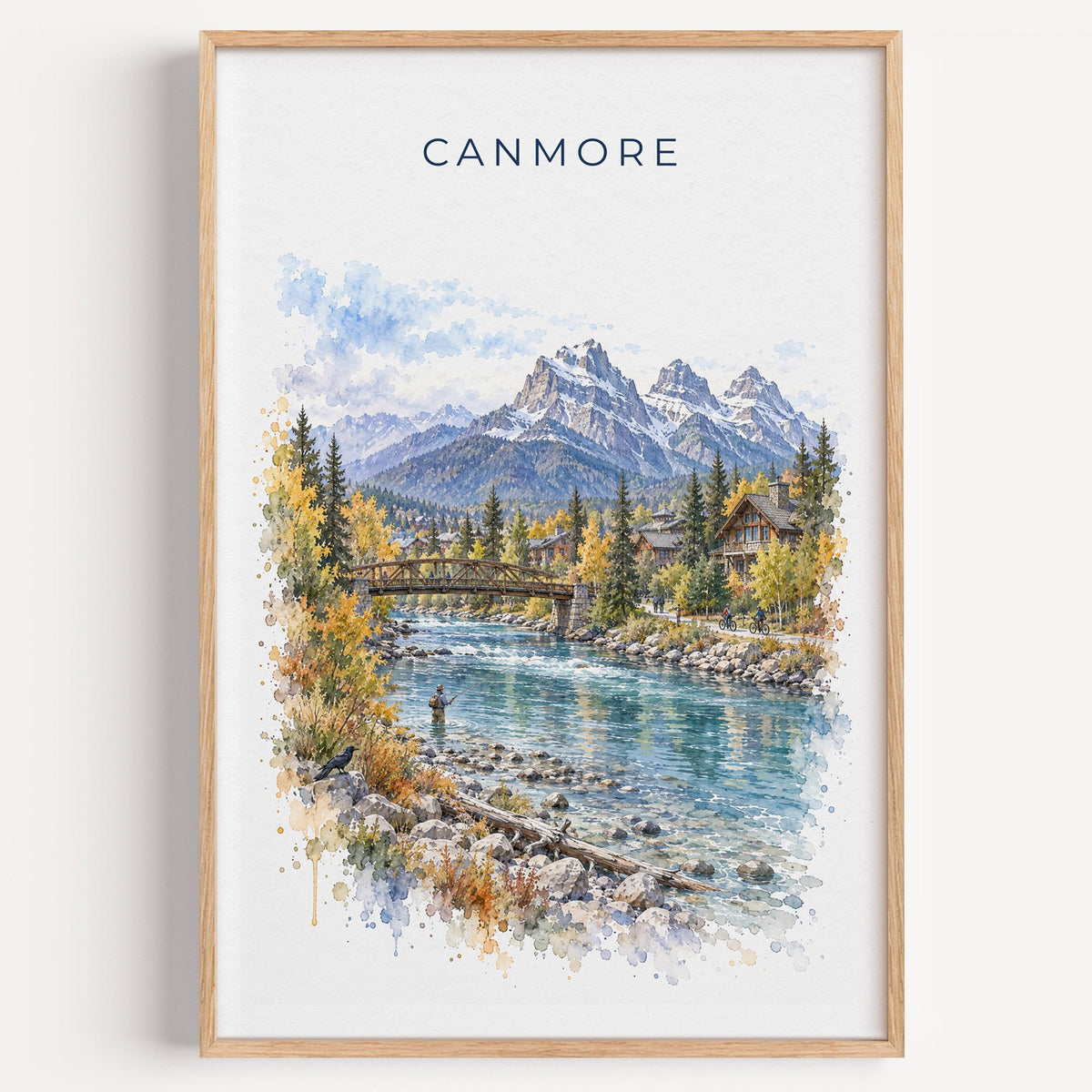 Canmore watercolor print in a light oak frame on a plain white wall