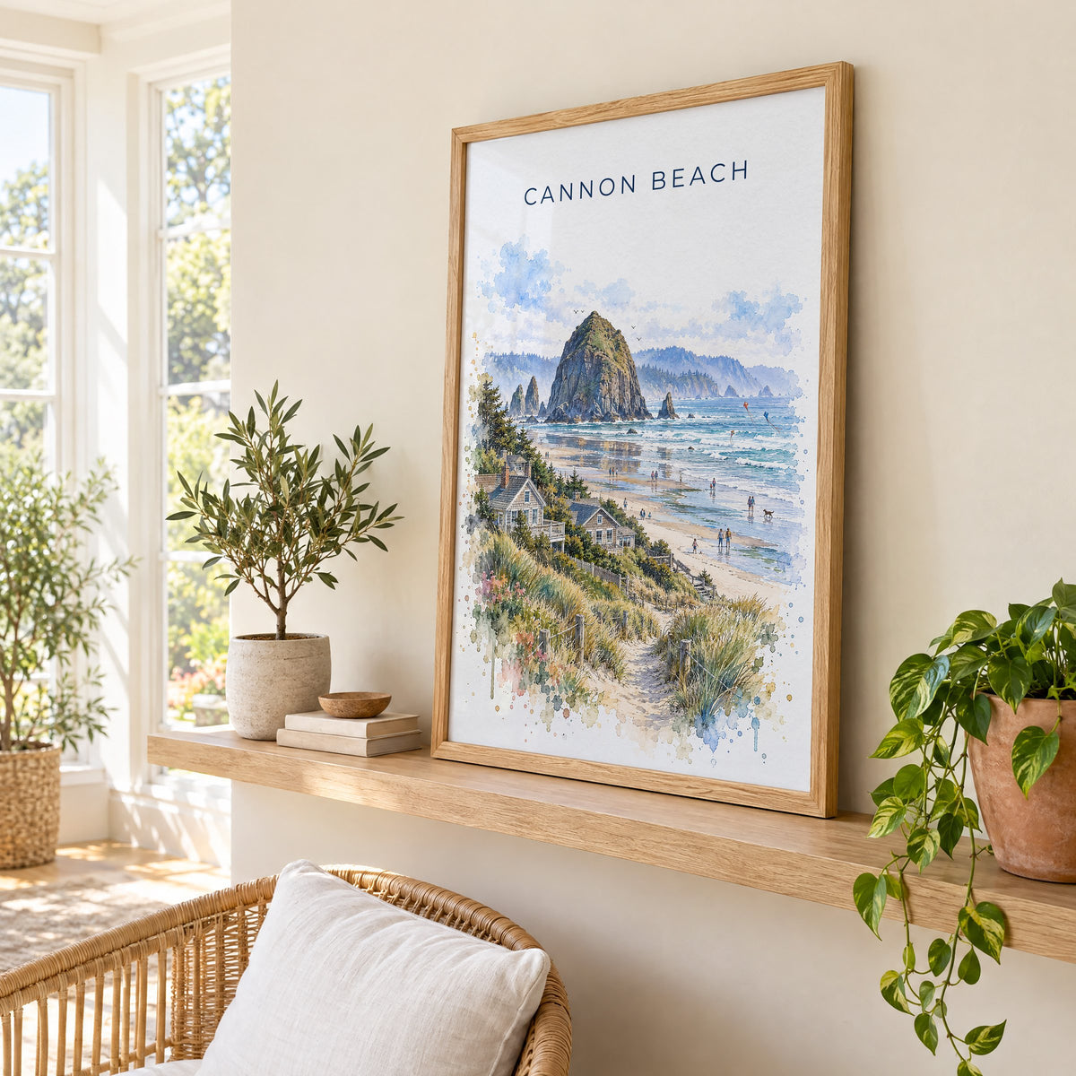 Cannon Beach watercolor print in an oak frame on a picture ledge in a sunlit sunroom