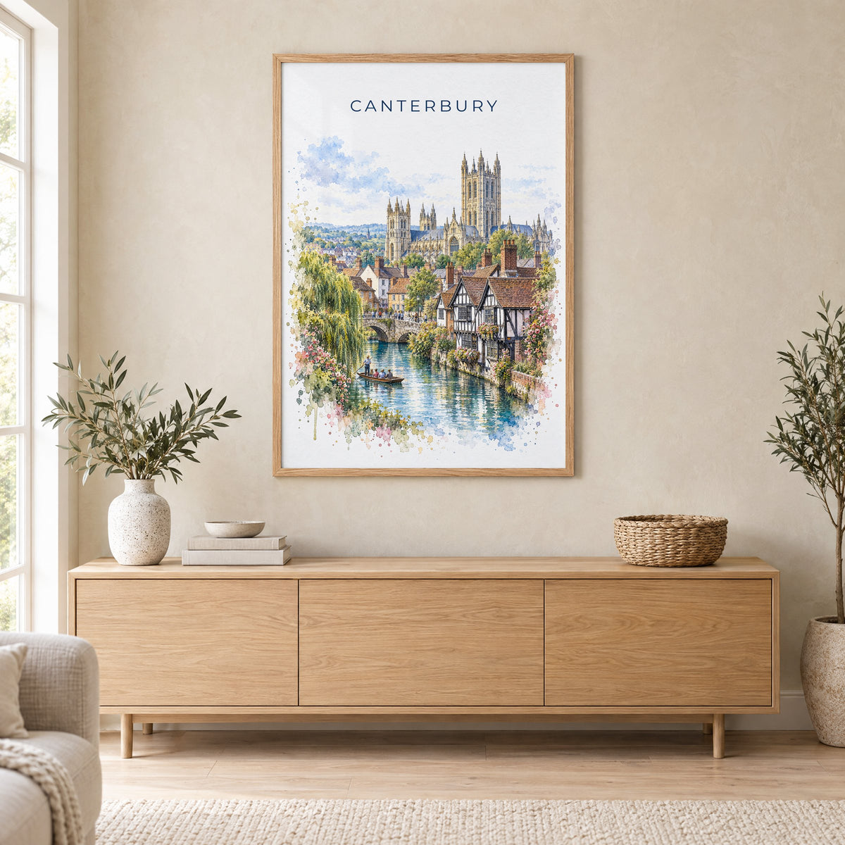 Canterbury, England watercolor print in an oak frame above a light wood sideboard in a Scandinavian living room