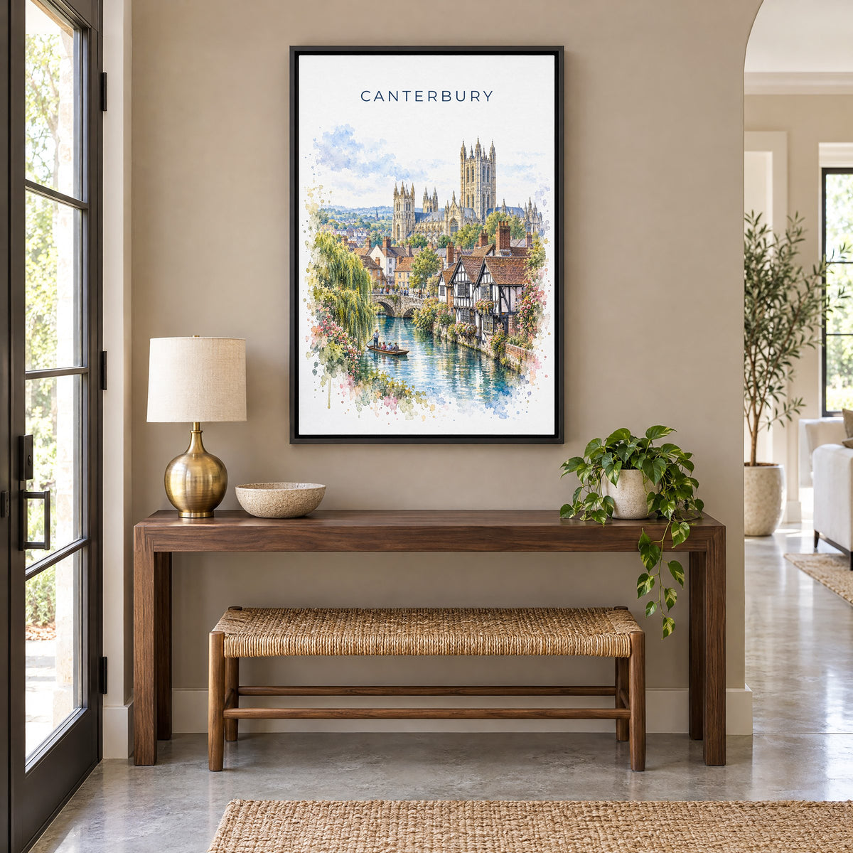 Canterbury, England watercolor print as a black floater canvas above a walnut console and woven bench in an entryway