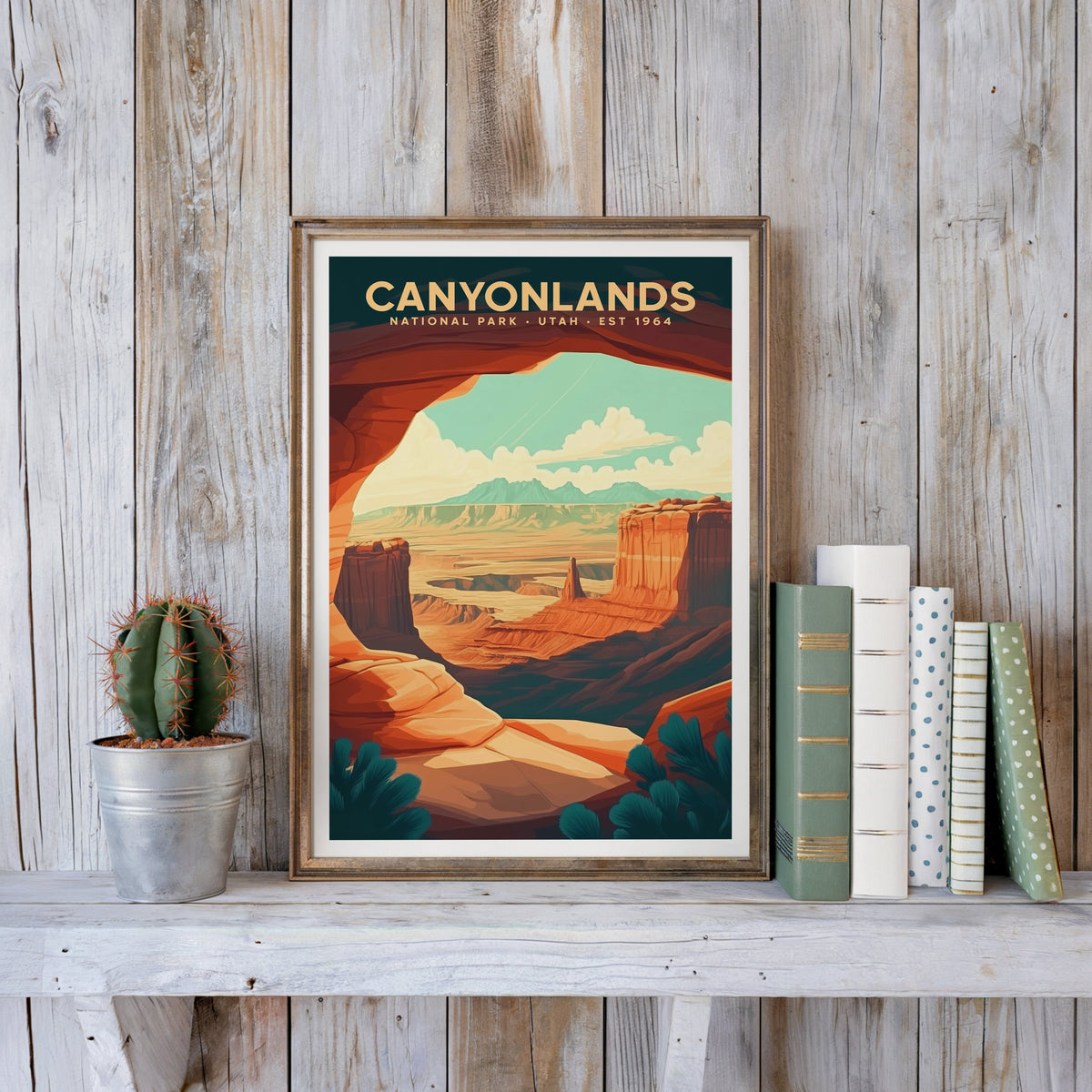 Canyonlands poster in an antique gold frame against whitewashed farmhouse planks beside books