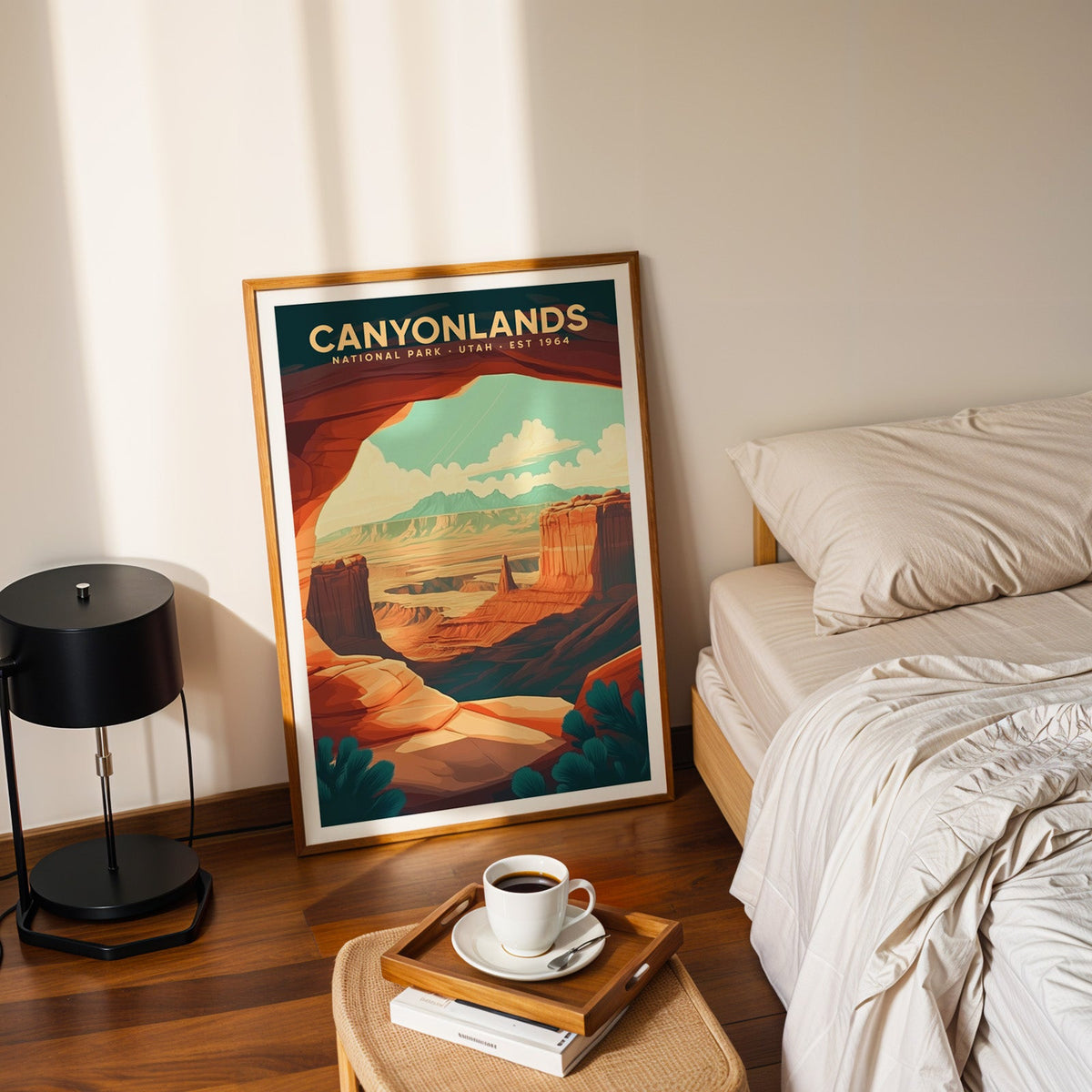 Canyonlands National Park print in an oak frame leaning on a bedroom floor beside the bed