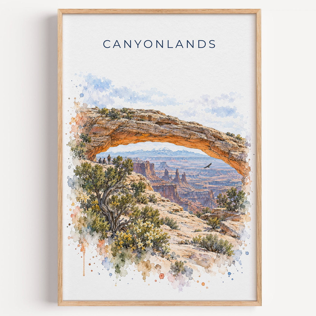 Canyonlands National Park watercolor print in a light oak frame on a plain white wall