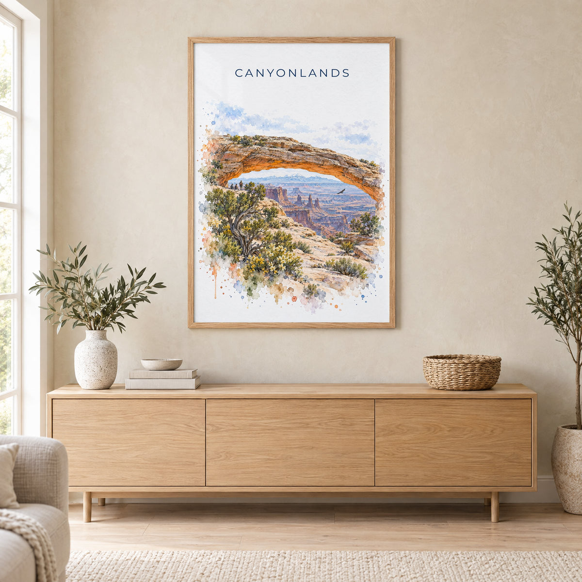 Canyonlands National Park watercolor print in an oak frame above a light wood sideboard in a Scandinavian living room