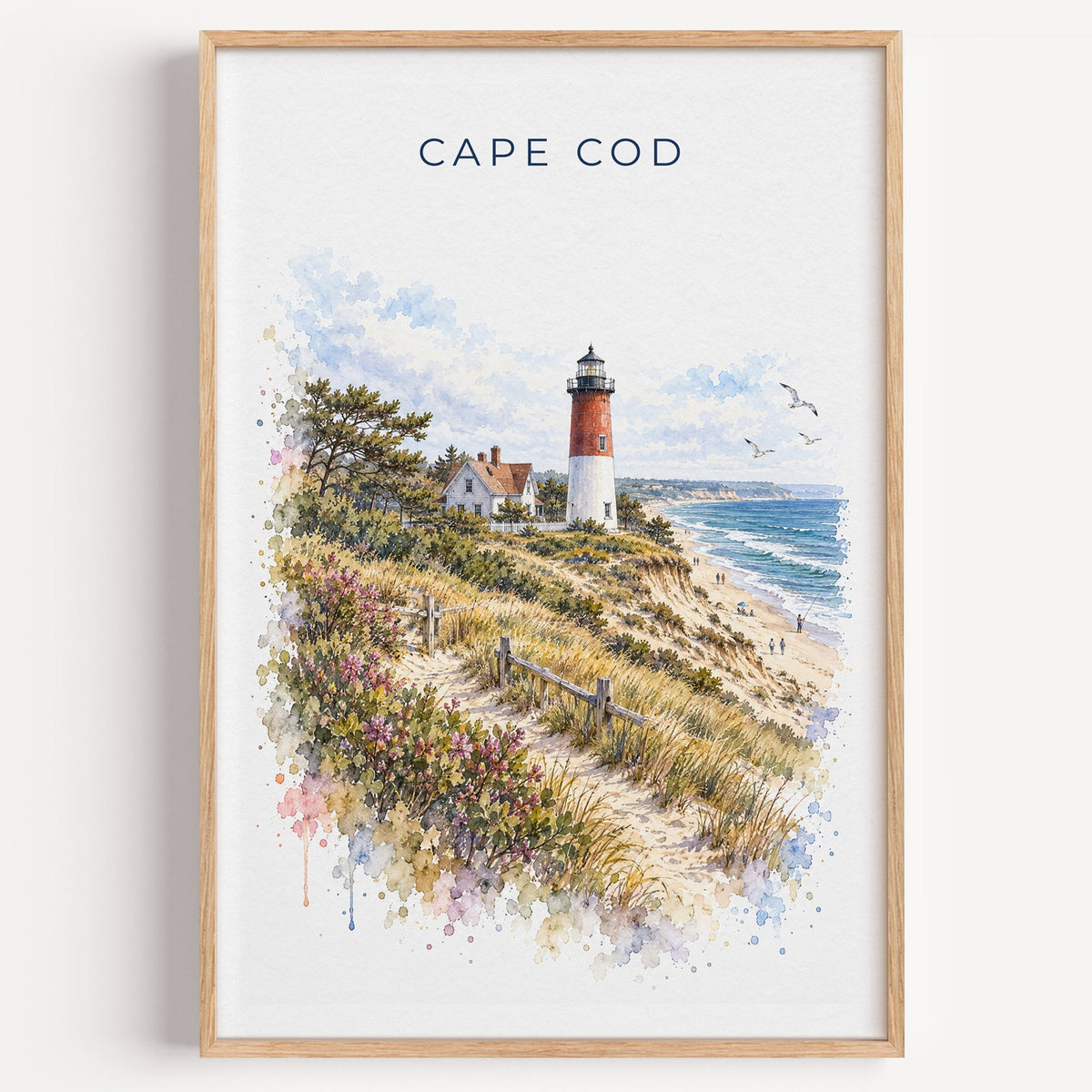 Cape Cod National Seashore watercolor print in a light oak frame on a plain white wall