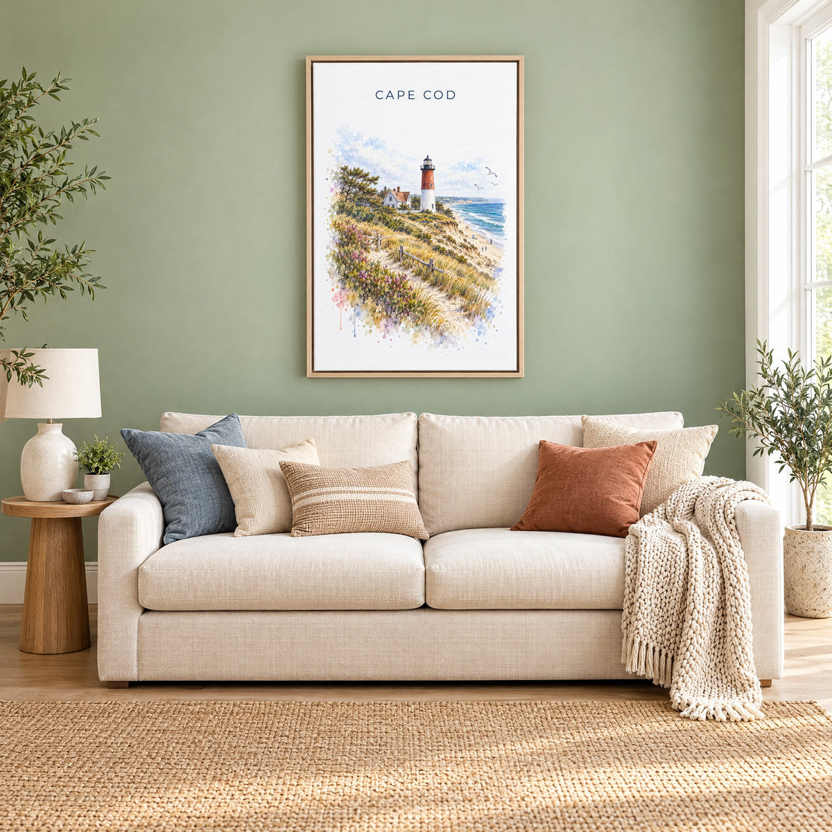 Cape Cod National Seashore watercolor print as a natural floater canvas above a cream linen sofa on a sage green wall