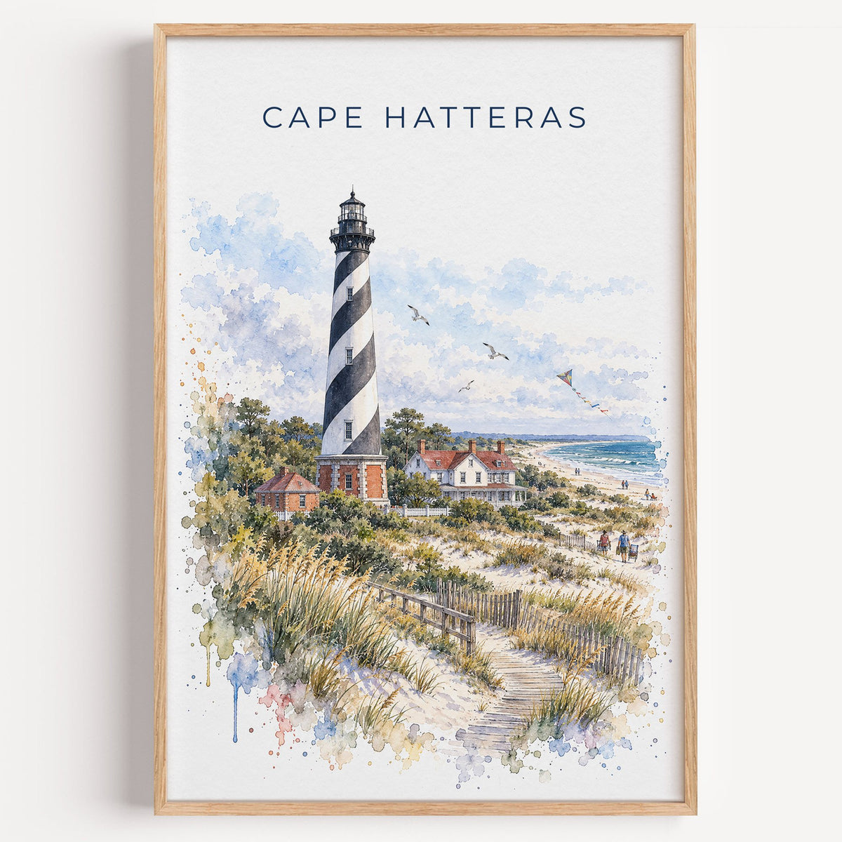 Cape Hatteras watercolor print in a light oak frame on a plain white wall