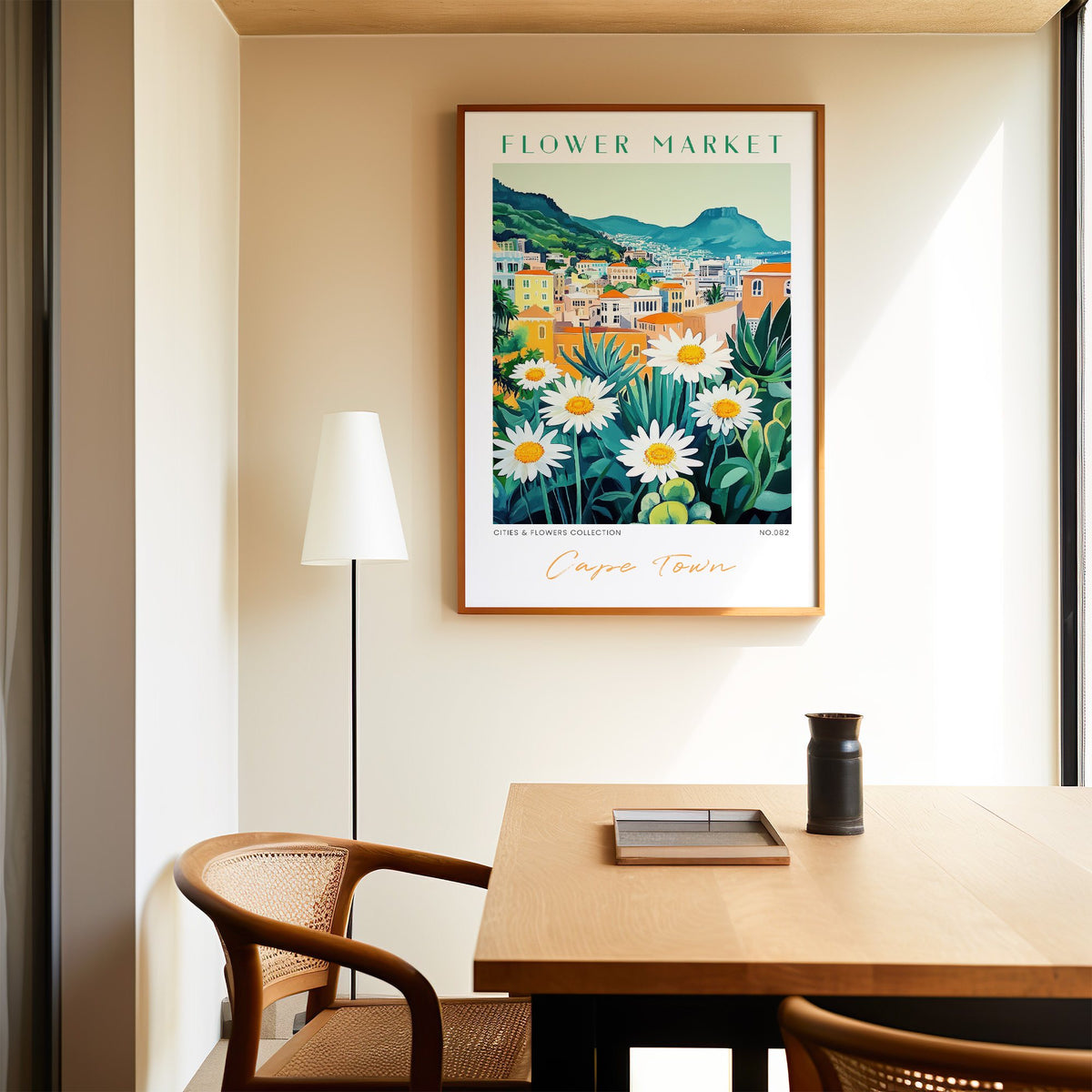 Cape Town flower market print in an oak frame above a dining table and cane chair