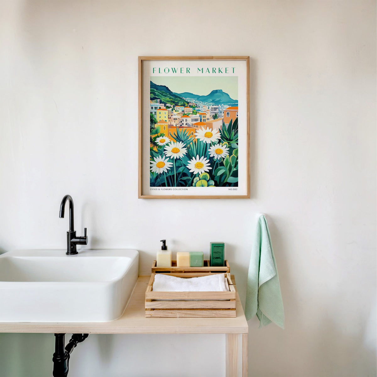 Cape Town flower market print in an oak frame above a white bathroom sink with folded towels