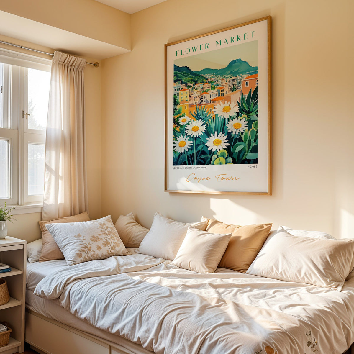 Cape Town flower market print in an oak frame above a cream daybed in a sunny bedroom