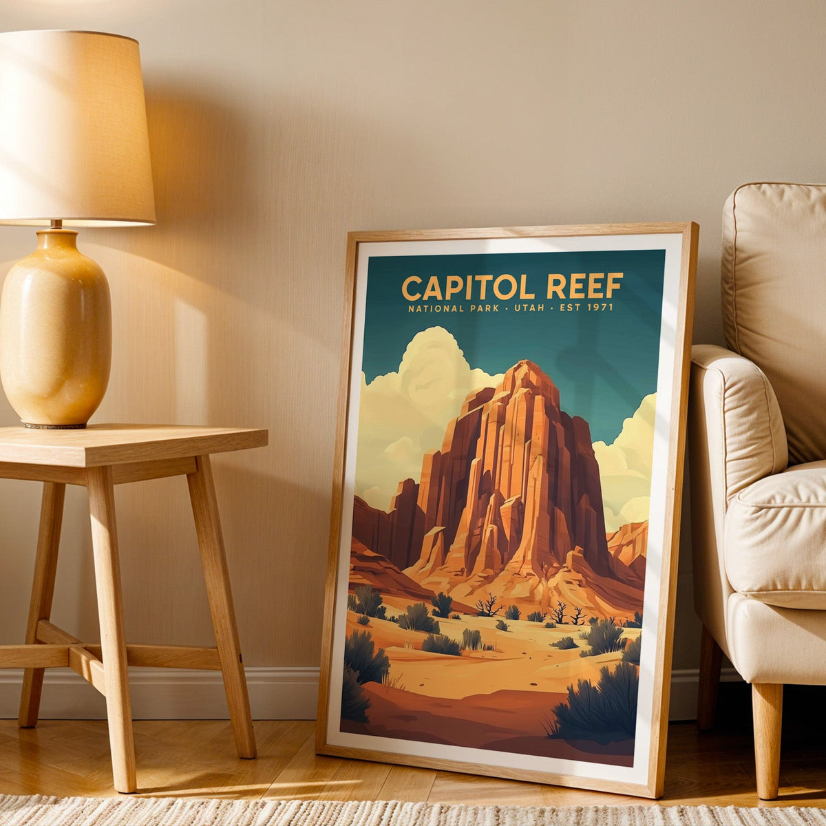 Capitol Reef print in an oak frame beside a cream armchair and an amber lamp in warm light