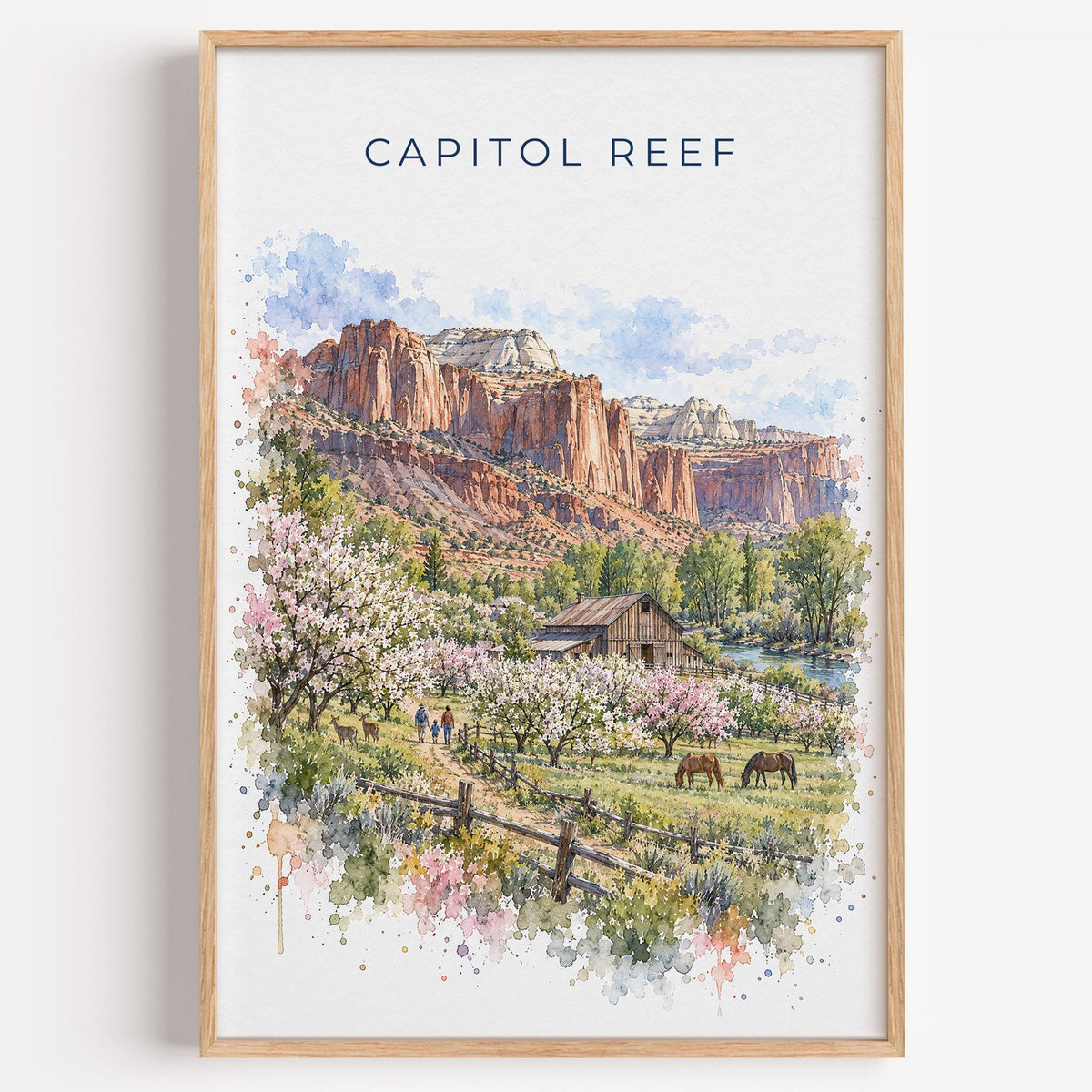 Capitol Reef National Park watercolor print in a light oak frame on a plain white wall
