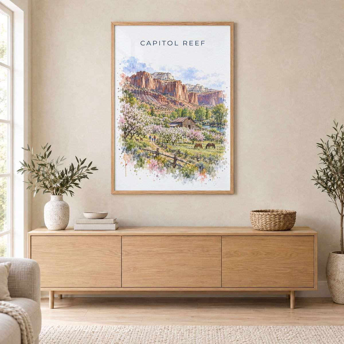 Capitol Reef National Park watercolor print in an oak frame above a light wood sideboard in a Scandinavian living room