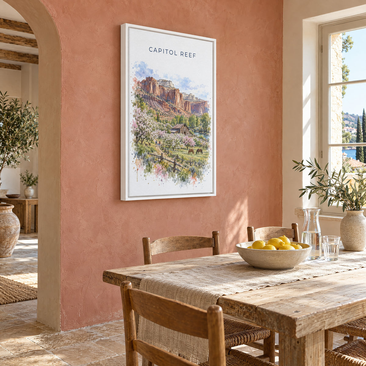 Capitol Reef National Park watercolor print as a white floater canvas on a terracotta wall above a rustic dining table