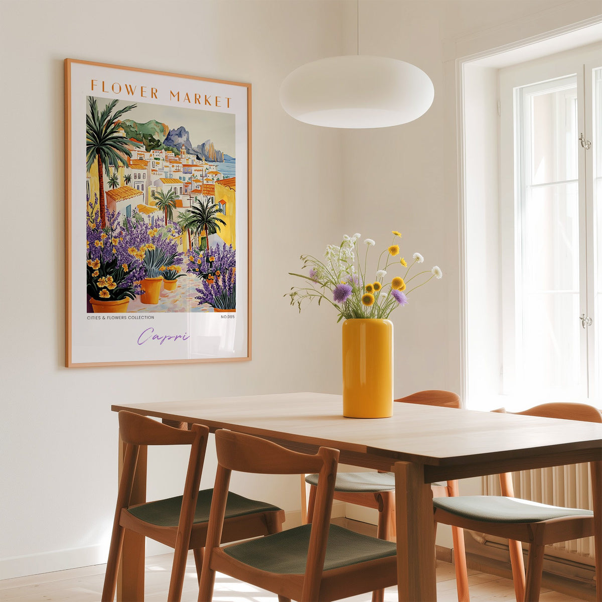 Capri flower market print in an oak frame above a dining table with a yellow vase and white pendant light