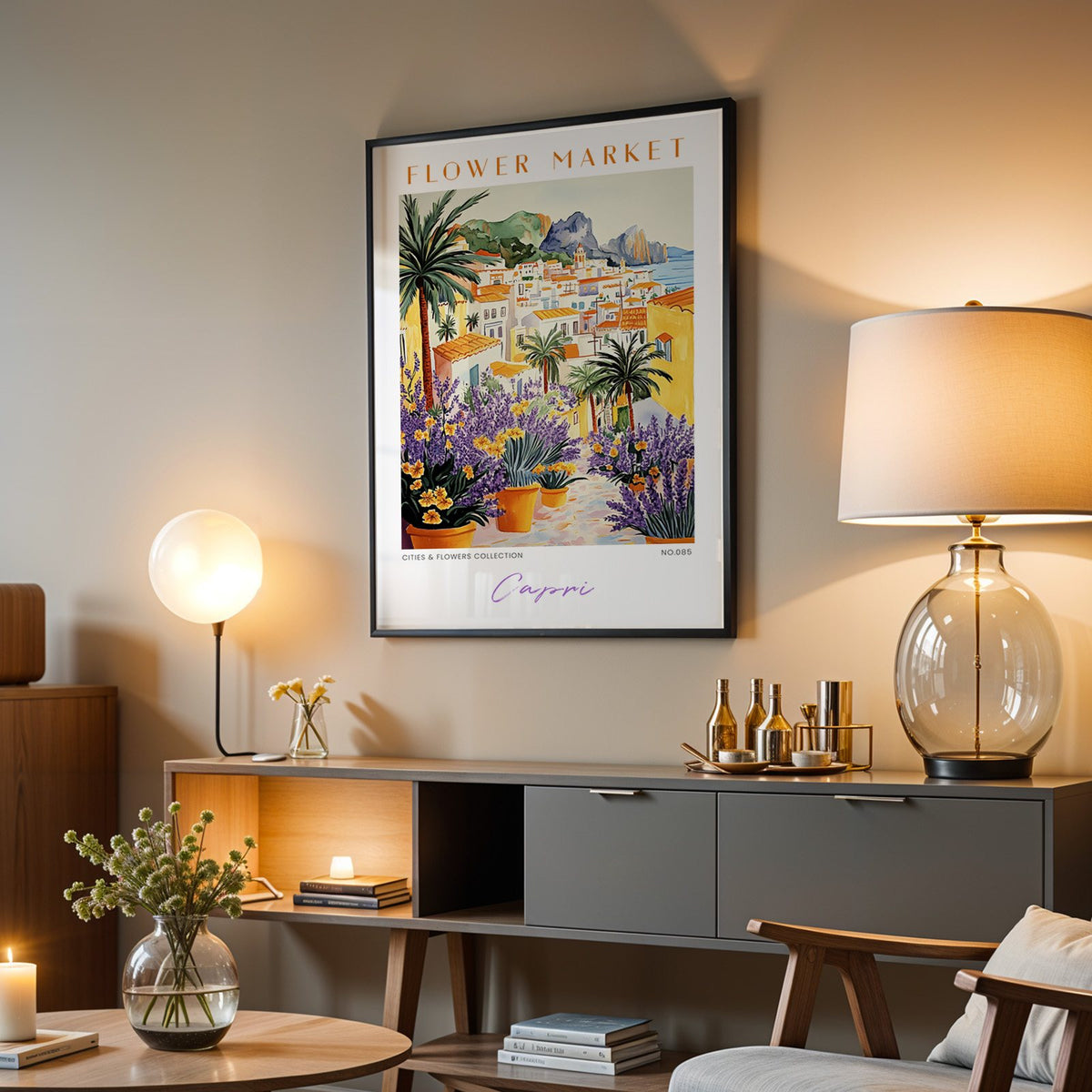 Capri flower market print in a black frame above a grey media console with a glass table lamp