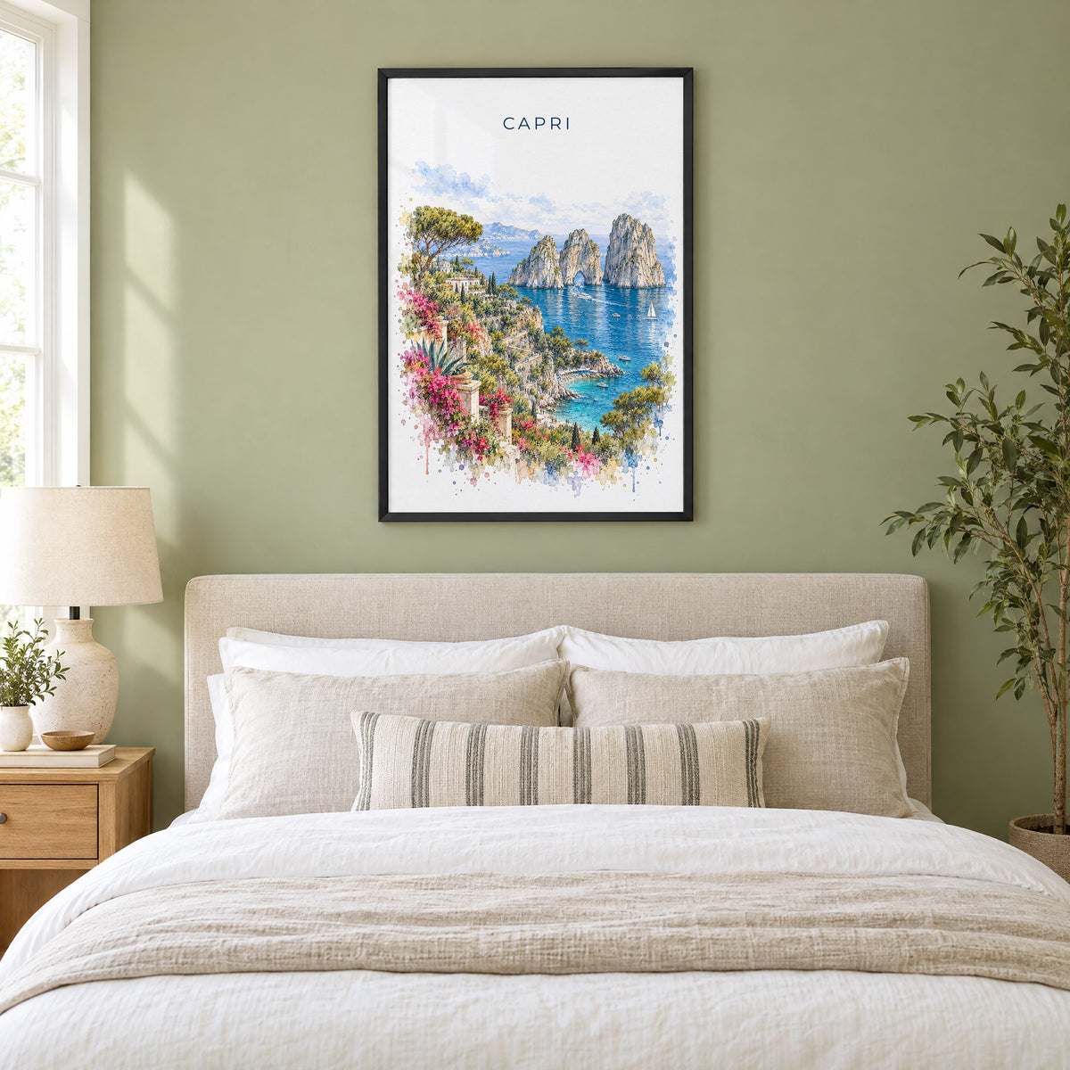 Capri watercolor print in a black frame above an upholstered headboard in a sage green bedroom