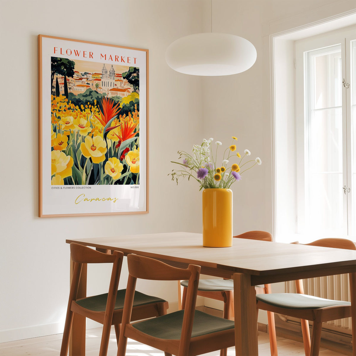 Caracas flower market print in an oak frame above a dining table with a yellow vase and white pendant light
