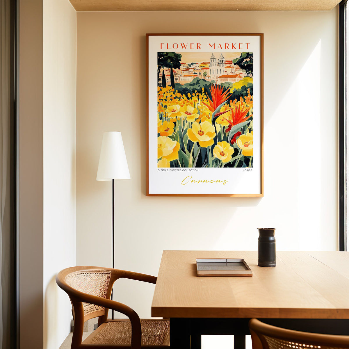 Caracas flower market print in an oak frame above a dining table and cane chair