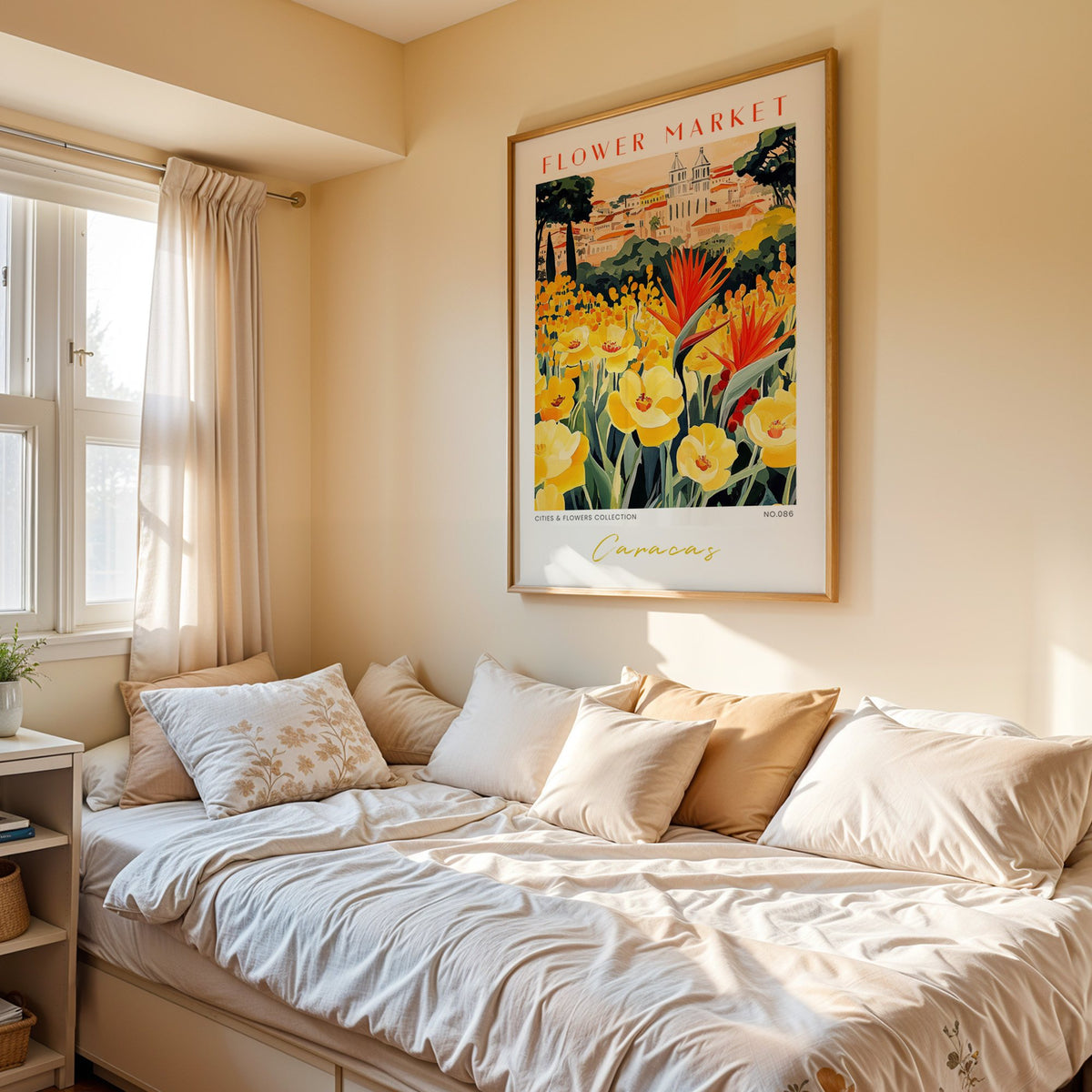 Caracas flower market print in an oak frame above a cream daybed in a sunny bedroom